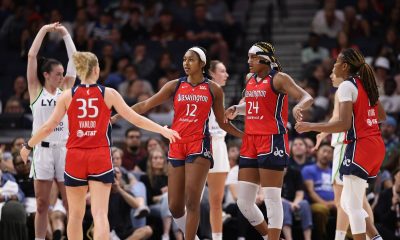 The Mystics come together on the court during a 2024 game (photo via John McClellan/Flickr)